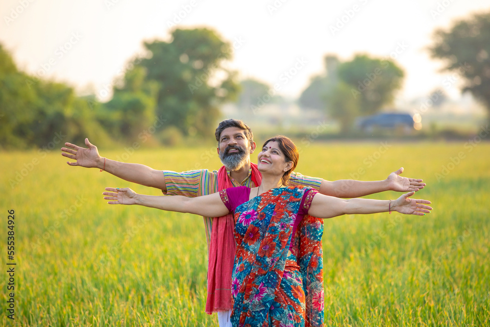 Indian farmer couple spreading hand and giving expression at ...