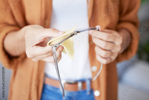 Cleaning glasses, cloth and woman hands doing eye care with fabric to clean lens and frame. Dust, dirt and care of a person at a optometrist or doctor office getting ready for vision test for health