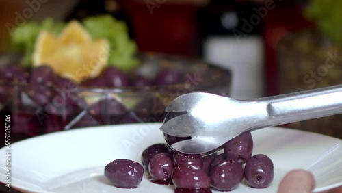 Serving in slow motion a delicious dessert of purple fruits like grapes on a plate. photo