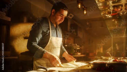 In Restaurant Professional Chef Preparing Pizza, Using Flour, Kneading Dough, Traditional Family Recipe. Authentic Pizzeria, Cooking Delicious Organic Food. Cinematic Focus on Hands Shot