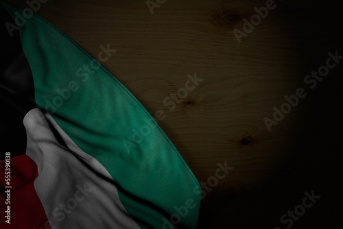 wonderful feast flag 3d illustration. - dark picture of Kuwait flag with large folds on dark wood with free place for content