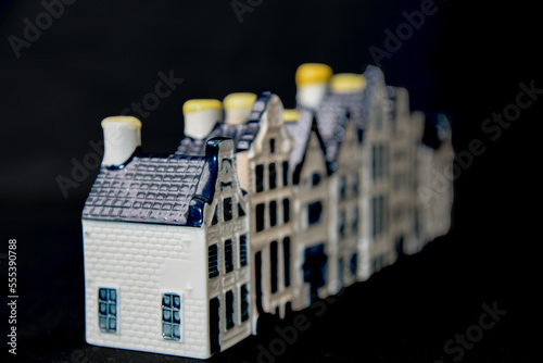 Den Helder, Netherlands. December 2022. Ceramic houses with Dutch gables on a black background.