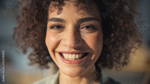 Close Up Portrait of a Beautiful Female Creative Specialist with Curly Hair Smiling. Young Successful Multiethnic Arab Woman Working in Art Studio. Dreaming About Better Life and Opportunities Ahead.