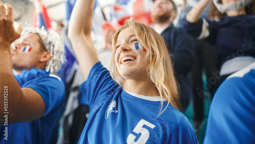 Sport Stadium Soccer Match: Portrait of Beautiful Caucasian Fan Girl with French Flag Painted Face Cheering For Her Team to Win. Crowd of Fans Shout, Celebrate Scoring a Goal, Championship Victory