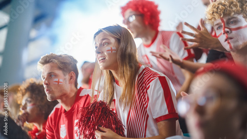 Sport Stadium Sport Event: Beautiful Cheering Girl. Crowd of Fans with Painted Faces Cheer, Shout for their Red Soccer Team to Win. People Celebrate Scoring a Goal, Championship Victory