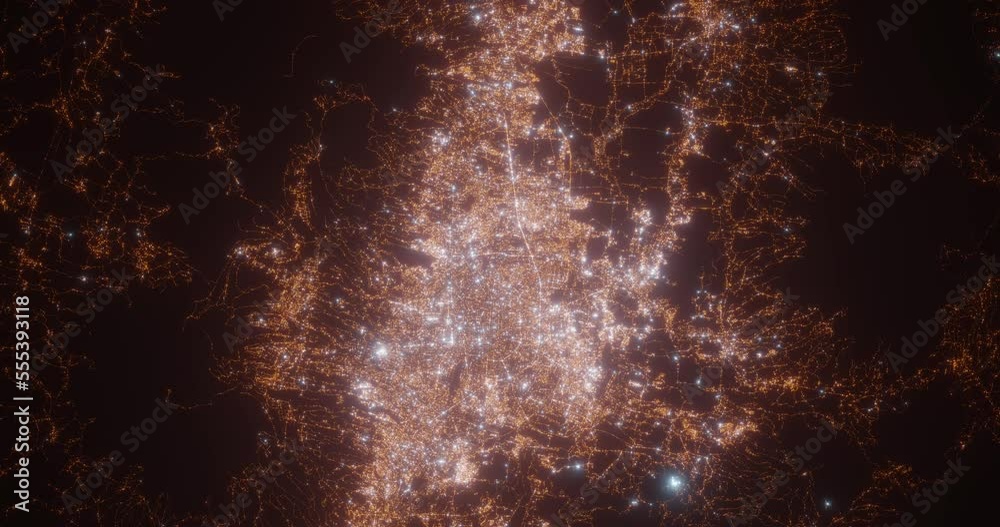 Bandung (Indonesia) aerial view at night. Top view on modern city with street lights. Camera is zooming out, rotating counterclockwise. Vertical video. The north is on the left side