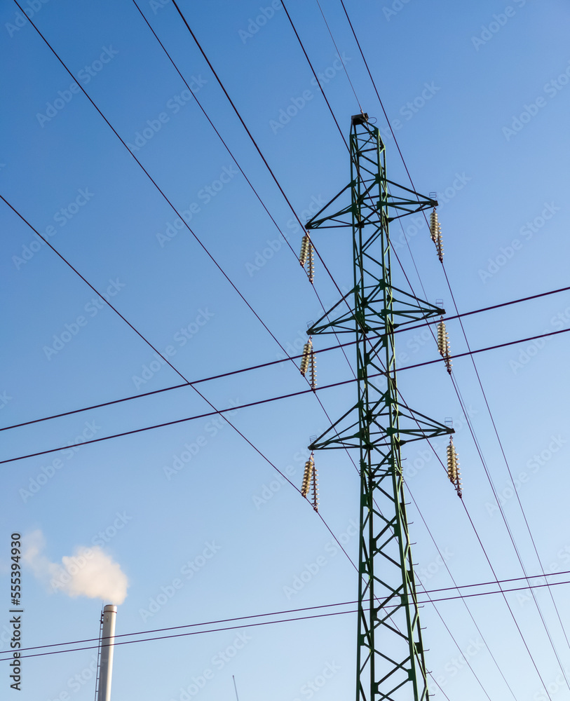 Factory chimney with smoke. Industrial pipe. Blue sky at sunny day. Air pollution. power line tower Factory chimney with smoke. Industrial pipe. Blue sky at sunny day. Air pollution. power line tower