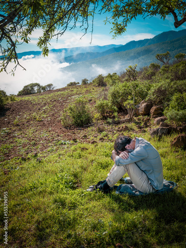 sad man sitting in the nature


