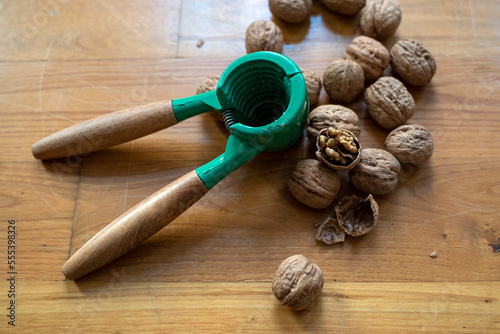 Walnuts and nutcraker on wooden board