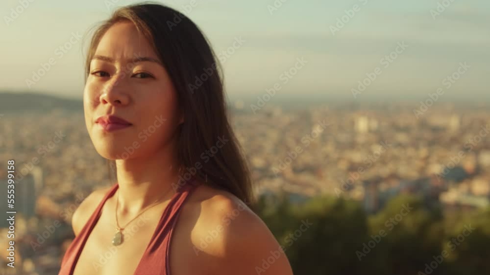 Close-up of young smiling woman looking at the camera while standing on viewing platform Close-up of young smiling woman looking at the camera while standing on viewing platform