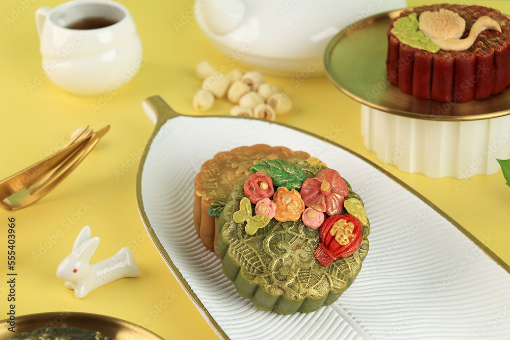 Green Tea Moon Cake with Golden Dust on Yellow Background.