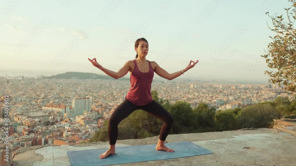Girl practices yoga asana at lookout point at dawn Girl practices yoga asana at lookout point at dawn