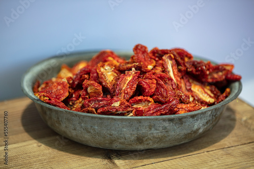 Close-up of part of an open basket full of healthy, shiny bright red sun-dried tomatoes in a market on the izmir Turkey. High quality photo