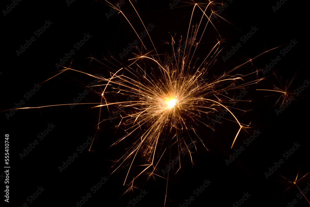 Sparkler on a black background.Close-up of burning sparkler.Fire