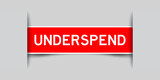 Inserted red color label sticker with word underspend on gray background