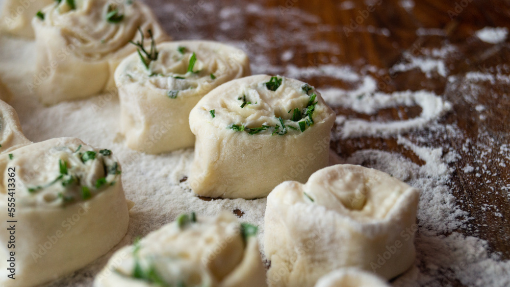 Raw pastry. Dough. The pastry is sprinkled with greens. Dough rolls. Raw pastry. Dough. The pastry is sprinkled with greens. Dough rolls.