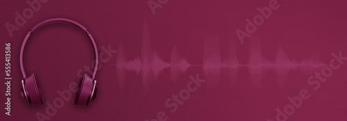 Purple banner for radio broadcast, music streaming or podcast content with headphones, audio waveform and copy space photo
