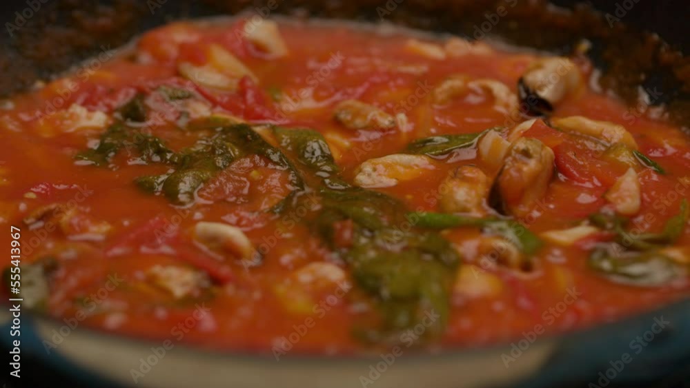 Seafood Cooking In Bubbling Tomato Sauce on Frying Pan in slow motion. Seafood Cooking In Bubbling Tomato Sauce on Frying Pan in slow motion.