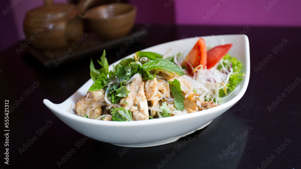 Asian combo plate with chicken and vegetables served with noddles. Asian combo plate with chicken and vegetables served with noddles.