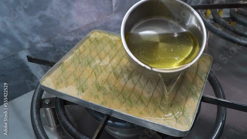 Chef at an oriental food stall in the market making Middle-Eastern Delicious traditional dessert kadayif kunefe with pistachios. Turkish dessert kadayif kunefe.
 photo