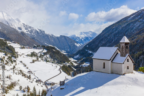 Church on a hill in a snowy alp valley © Lars Johansson