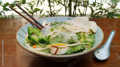 Vegan Vietnamese Pho Soup. Phở, often written as pho, is a traditional Vietnamese dish based on what is generically called a noodle soup. photo