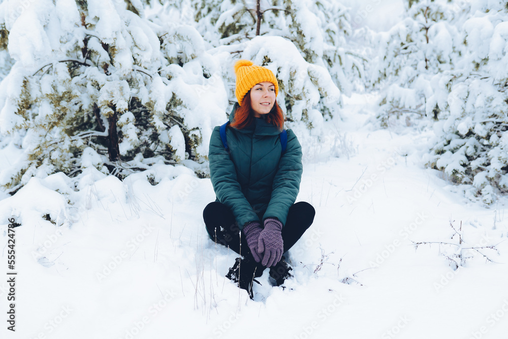 Cheerful girl in warm clothes playing with snow outdoors near the beautiful forest Cheerful girl in warm clothes playing with snow outdoors near the beautiful forest