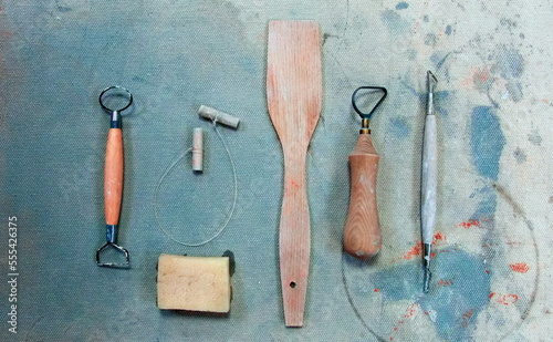 Pottery tools on Dirty Grunge Background in a pottery workshop. Toned Photo