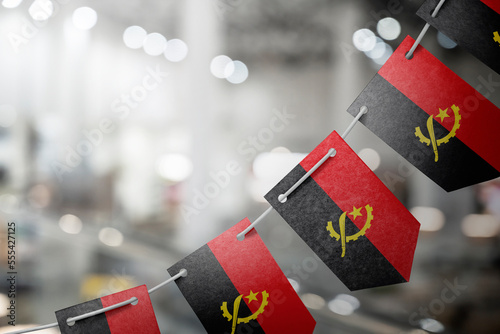 A garland of Angola national flags on an abstract blurred background photo