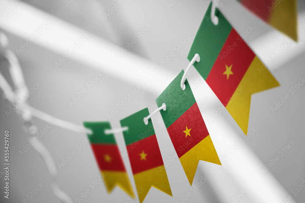 A garland of Cameroon national flags on an abstract blurred background