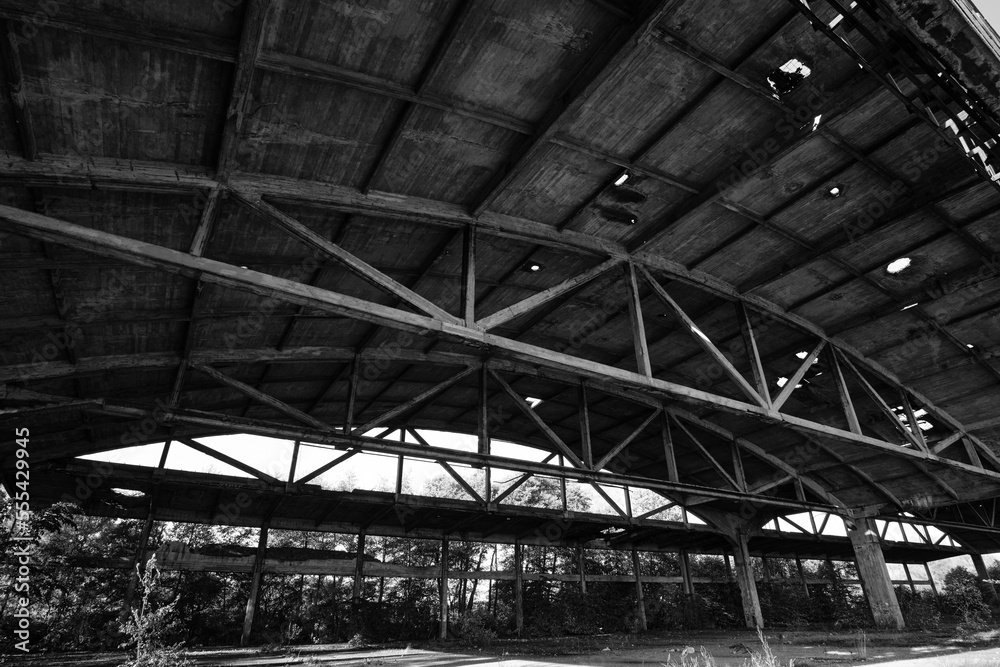 Old arched metal structures abandoned air hangar.