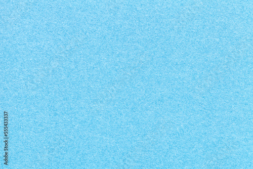 Texture of old craft light blue paper background, closeup. Structure of a vintage cerulean cardboard.