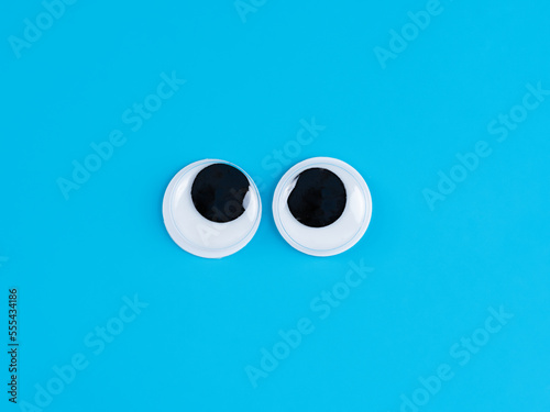 funny  googly eyes cute  Isolated on bright light blue  background copy space logo