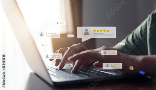 Customer review good rating concept, hand pressing user and five star icon on visual screen for positive customer feedback, testimonial and testimony, user comment and feedback for review. photo