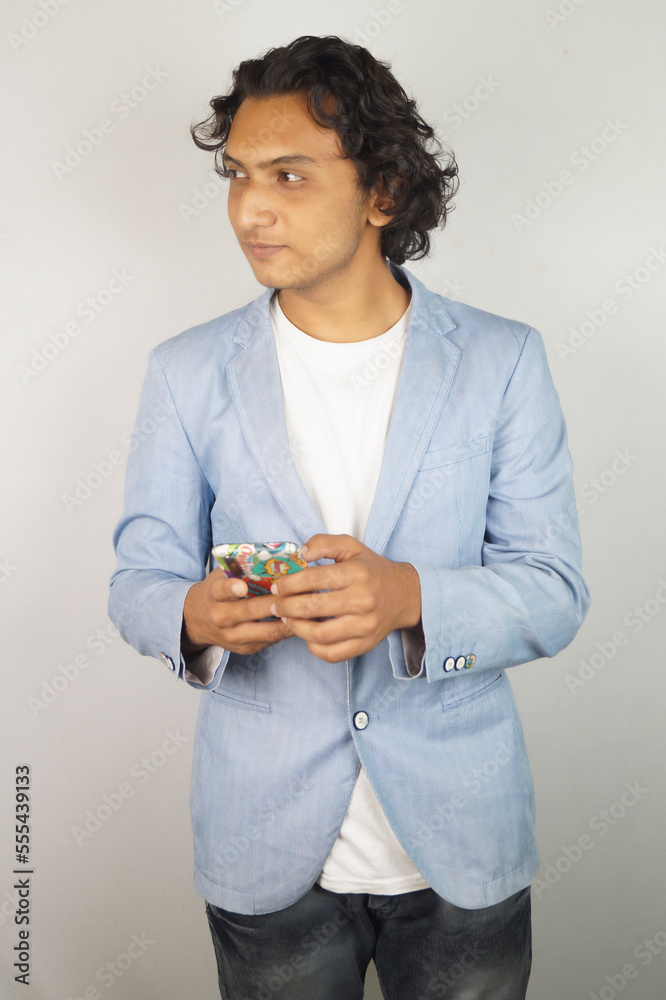 Smiling man looking away while using mobile phone Smiling man looking away while using mobile phone