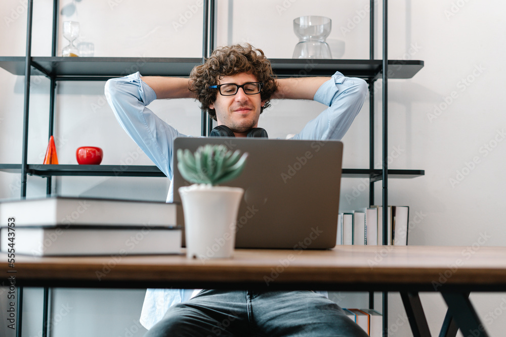 Freelancer working online in home office, Smart Businessman thinking, relaxing and looking at laptop computer on his desk in office
