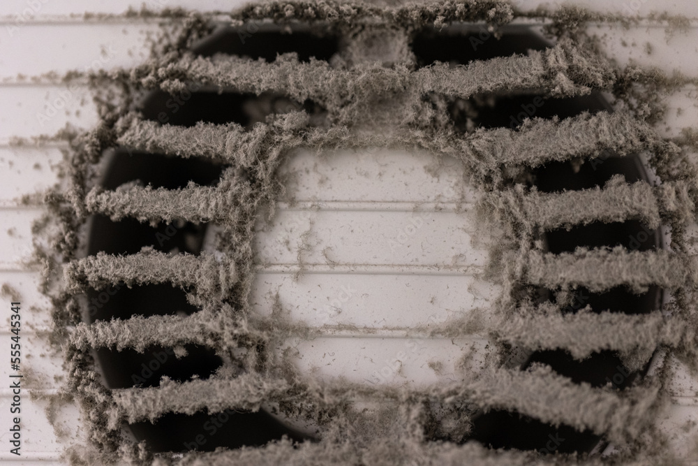 Very dirty and dusty white plastic air vent. The ventilation shaft in