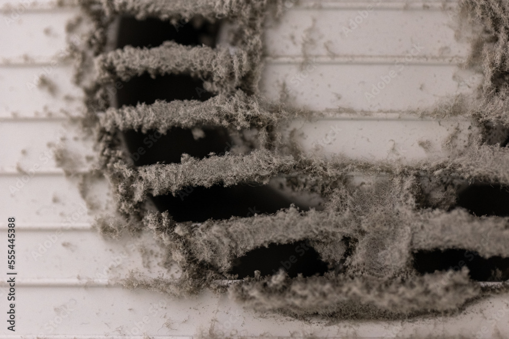 Very dirty and dusty white plastic air vent. The ventilation shaft in