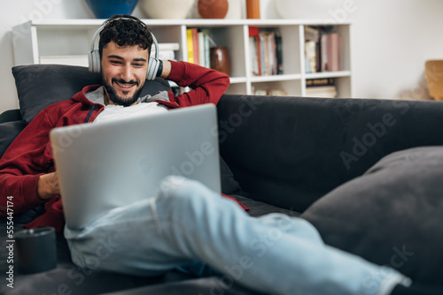 Young man enjoys video call at home