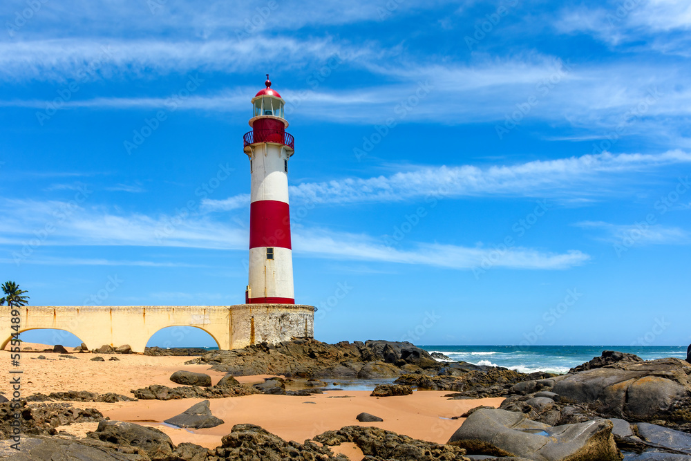 Famous colorful lighthouse on the sands of the famous Itapua beach in the city of Salvador in Bahia