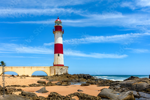 Famous colorful lighthouse on the sands of the famous Itapua beach in the city of Salvador in Bahia