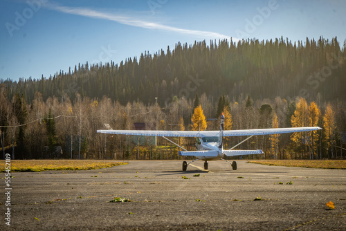A small plane on the runway of a civil airport prepares to take off