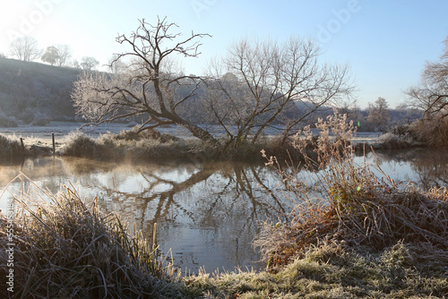 Winter reflections on the River Wey on a cold and frosty day. photo