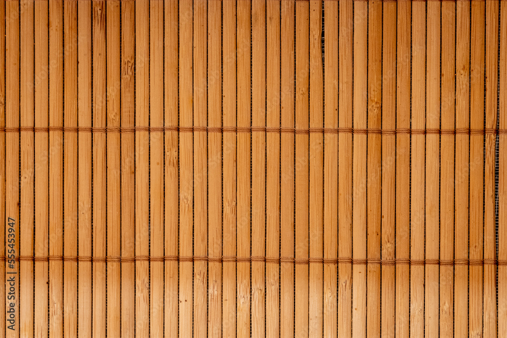 Brown bamboo texture background coming from natural bamboo straws. The oriental asian fencing has a beautiful yellow pattern, fence texture in daytime Brown bamboo texture background coming from natural bamboo straws. The oriental asian fencing has a beautiful yellow pattern, fence texture in daytime