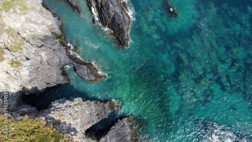 Turquoise waters of the Atlantic Ocean and large coastal cliffs. Beautiful seascape, top view. Aerial photo.