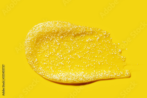 yellow smear of shower scrub\peeling with bubbles and white particles, cosmetic textures, skincare product swatch