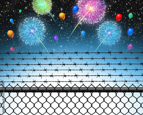 Inequality And New Year Celebration as a fence with barbed wire separating a divided society from the rich celebrating with fire works during the Holiday season  photo