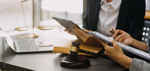 Male lawyer working with contract papers and wooden gavel on tabel in courtroom. justice and law ,attorney, court judge, concept.