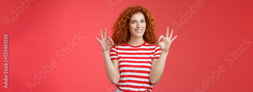 Fine relax everything perfect. Satisfied good-looking redhead cheerful sassy girlfriend curly haristyle show okay ok confirm gesture smiling approval agree good terms stand red background