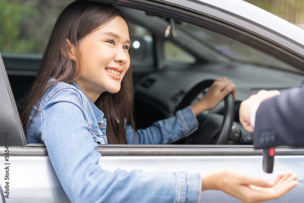 Business car rental, sell or buy service, dealership hand of agent dealer, sale man giving auto key of vehicle to customer renter, buyer young woman receiving, client or tenant, transfer automobile. Business car rental, sell or buy service, dealership hand of agent dealer, sale man giving auto key of vehicle to customer renter, buyer young woman receiving, client or tenant, transfer automobile.